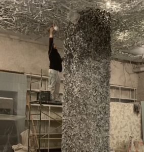 Complete restaurant interior transformation with artistic ceiling installations and decorative columns by Mural Way