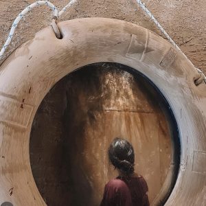 Large-scale wooden barrel entrance installation creating immersive decorative experience for Dubai event