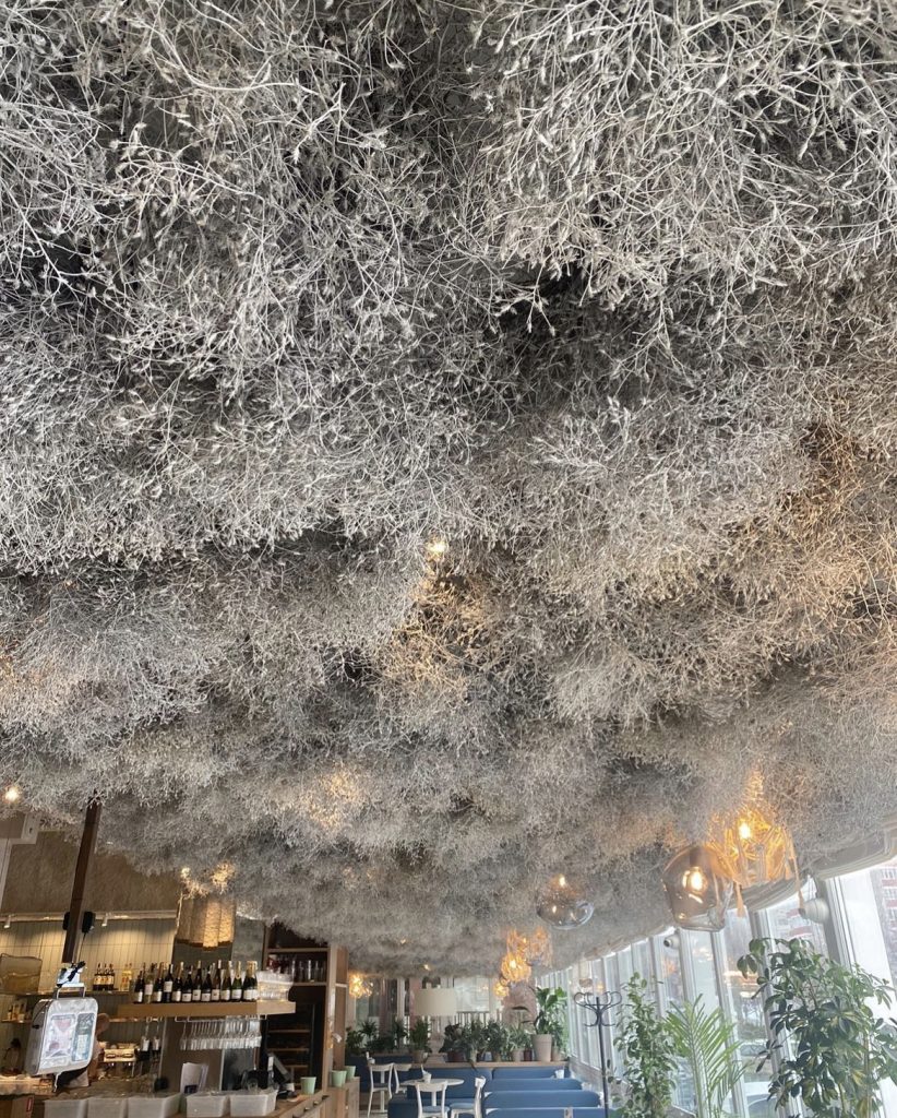 Dramatic restaurant ceiling transformation with sculptural installation and atmospheric lighting in Dubai